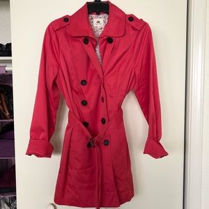 Pink raincoat with black buttons